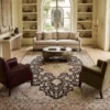 Persian Heriz wool rug 6' 10" x 10' 0" styled in an upscale Mediterranean living room under a round coffee table.