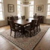 Black and cream Persian Heriz wool rug beneath a mahogany dining room table with six chairs.