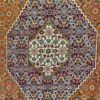 Close-up detail of the stepped diamond medallion and fine Mahi fish pattern on a hand-knotted Persian wool carpet.