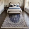 6' 9" x 10' 4" Persian Nain wool rug placed under a queen bed with blue pillows and an upholstered bench in a quiet bedroom setting.