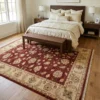 Hand-knotted 6' 8" x 9' 7" Afghan Chobi wool rug placed under a dark wood bed with a bench in a cozy master bedroom.