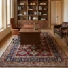 Afghan Kazak wool carpet styled in an executive office under a walnut writing desk and leather chair.