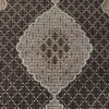 Close-up of the stepped diamond medallion and fine Mahi fish weave on a hand-knotted wool carpet.