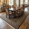 Hand-knotted India Mahi wool carpet placed under a mahogany dining table with six beige upholstered chairs.