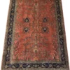 Full overhead view of a 6' 6" x 9' 11" hand-knotted Indian Sarough design wool rug featuring an open terracotta red field with botanical sprays and an indigo floral border.
