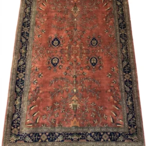 Full overhead view of a 6' 6" x 9' 11" hand-knotted Indian Sarough design wool rug featuring an open terracotta red field with botanical sprays and an indigo floral border.
