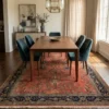 Hand-knotted Indian Sarough wool area rug placed under a walnut dining table with teal velvet chairs.
