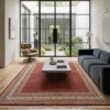 6' 9" x 9' 8" Indian wool area rug styled in a modern living room with a grey modular sofa and leather lounge chair.