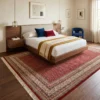 Hand-knotted Indian wool area rug extending beneath a wooden platform bed in a warm, minimalist master bedroom.