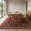 Hand-knotted Persian Bakhtiar wool area rug styled under a light wood dining table with six cream chairs.
