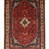 Full overhead view of a 6' 11" x 10' 4" hand-knotted Persian Hamedan wool rug featuring a rich red field, cream central medallion, navy spandrels, and a floral cream border.
