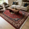 6' 11" x 10' 4" Persian Hamedan wool rug styled in a modern living room under a low wood coffee table, cream sofa, and accent chairs.
