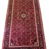 Full overhead perspective of a 5' 6" x 10' 4" hand-knotted Persian Hoseinabad wool runner rug with an 8-point star medallion on a rich red field.