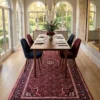 Hand-knotted Persian Hoseinabad wool rug 5' 6" x 10' 4" placed under a long wooden dining table with navy and burgundy velvet chairs.