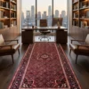 Long 5' 6" x 10' 4" Persian Hoseinabad wool runner rug laid in a modern high-rise executive office with city view and dark wood floors.