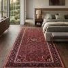 Hand-knotted 5' 6" x 10' 4" Persian Hoseinabad wool rug placed alongside a modern upholstered bed in a cozy contemporary bedroom.