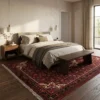 6' 8" x 10' 4" Persian Hoseinabad wool rug placed under a modern upholstered bed in a cozy bedroom setting.