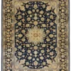 Full overhead view of a 7' 0" x 9' 10" hand-knotted Persian Najafabad wool rug with a midnight blue field, central ivory-gold medallion, and Shah Abbas floral borders.