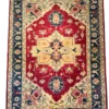 Full overhead view of a 6' 0" x 9' 0" hand-knotted Afghan Kazak wool rug featuring a large stepped ivory-gold medallion on a rich red field with a deep navy border.