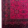 Detailed corner view of an Afghan Torkman wool rug showing the dark multi-tiered border bands, crenellated guard lines, and fringe.