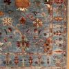 Detailed corner view of an Afghan Uzbek wool rug showing the tree-of-life border, geometric guard band, and multicolored tassel fringe.