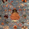 Close-up of the hand-knotted wool pile showing an intricate stylized pomegranate and blooming floral branches on a blue Afghan Uzbek rug.