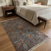 Blue Afghan Uzbek wool rug placed along the side of a walnut platform bed in a serene master bedroom.