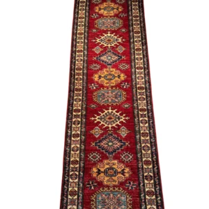 Full overhead view of a 2' 6" x 10' 0" hand-knotted Afghan Kazak wool runner rug featuring a vertical row of geometric tribal medallions in blue, gold, and ivory on a vibrant red field.