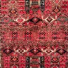Close-up of tribal latch-hook motifs, geometric cartouches, and rich wool pile on an Afghan Torkman area rug.