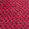 Close-up of repeating octagonal gul medallions, diamond lattice lines, and fine wool pile on a deep red Afghan Torkman rug.