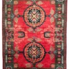 Full overhead view of a 5' 0" x 7' 0" hand-knotted Afghan Uzbek wool rug featuring two large circular medallions on a rich crimson red field with a dark green geometric floral border.