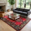 5' 0" x 7' 0" Afghan Uzbek wool rug styled in a sunlit living room with a glass-top wood coffee table, charcoal grey sofa, and caramel leather chair.