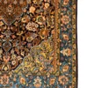 Detailed corner view of a Persian Isfahan rug displaying a turquoise floral border, golden-yellow spandrel, and neat white fringe.