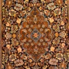 Close-up of the cognac and turquoise medallion, intricate floral arabesques, and fine wool and silk pile on a Persian Isfahan rug.