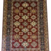 Full overhead view of a 6' 11" x 9' 10" hand-knotted Afghanistan Kazak wool rug with a rich rust-red field, geometric medallions, and a navy blue border.
