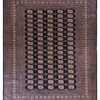 Full overhead view of a 7' 3" x 9' 11" hand-knotted Pakistan Bokhara wool rug featuring a dark navy field with repeating oval gul motifs and a wide geometrically patterned border.