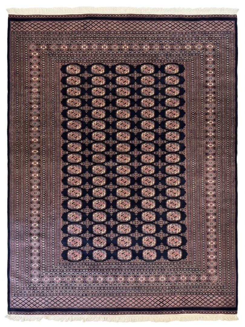 Full overhead view of a 7' 3" x 9' 11" hand-knotted Pakistan Bokhara wool rug featuring a dark navy field with repeating oval gul motifs and a wide geometrically patterned border.