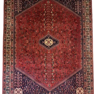 Full overhead view of a 6' 7" x 10' 3" hand-knotted Persian Abadeh wool rug featuring a large hexagonal red field with a central diamond medallion, dark blue spandrels, and bird motifs.