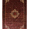 Full overhead view of a 6' 8" x 10' 4" hand-knotted Persian Hoseinabad wool rug with an eight-point geometric star medallion on a rich crimson red field.