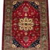 Full overhead view of a 6' 0" x 8' 0" hand-knotted Afghan Kazak wool rug featuring an ornate gold floral medallion, deep navy stepped spandrels, and a moss-green tribal border on a rich crimson red field.