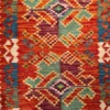 Close-up of the flat-weave slit-weave wool texture, stepped geometric diamond medallions, and natural dye colors on an Afghan Kilim rug.