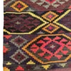 Detailed corner view of an Afghan Kilim wool rug showing the geometric stepped diamond border, selvage edge, and fringe tassels.