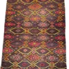 Full overhead view of a 7' 0" x 12' 0" hand-knotted Afghan Kilim wool rug featuring an all-over repeating diamond lattice with tribal eye and geometric motifs in charcoal, burgundy, ochre yellow, and coral red.